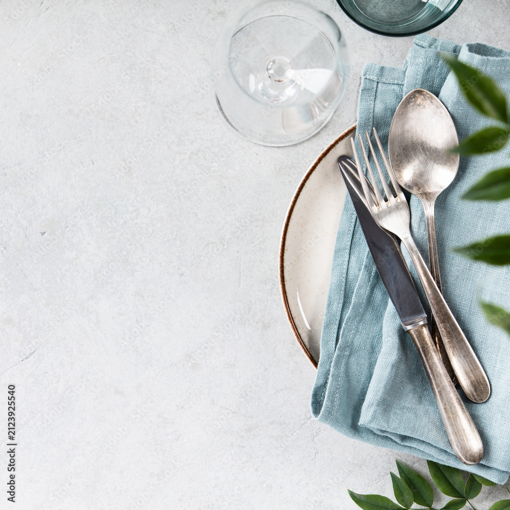 Obraz premium Elegant Table Setting with Vintage Cutlery and Greenery