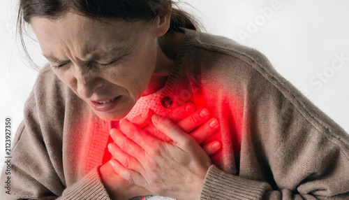 Chest Pain Concept – Woman Holding Chest with Severe Heart Discomfort