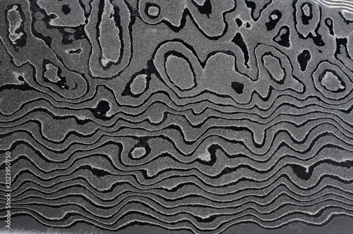 Surface of the Damascus steel blade with a unique wavy pattern