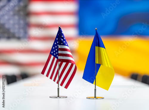 Canvastavla Miniature national flags displayed on a white conference table with blurred coun