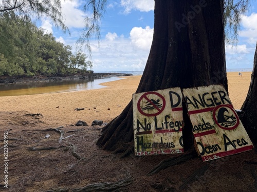 Danger warning sign on a secret beach in the tropics