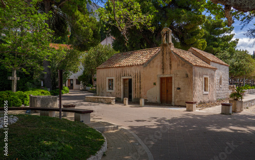 Ancient stone chapel sits beneath lush green trees