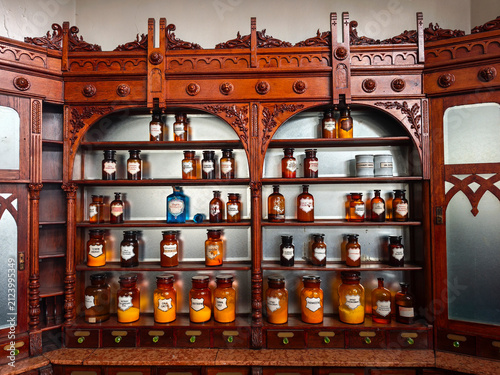 Collection of recipients of chemical substances in an old vintage pharmacy.