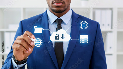 African American businessman interacting with a digital cloud computing interface for data storage and network security