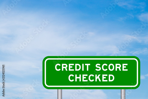Green color transportation sign with word credit score checked on blue sky with white cloud background