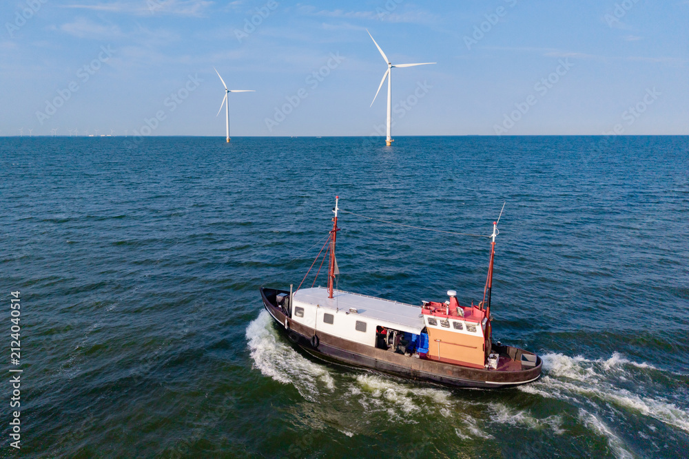 Fototapeta premium Exploring windmill park in flevoland's blue waters