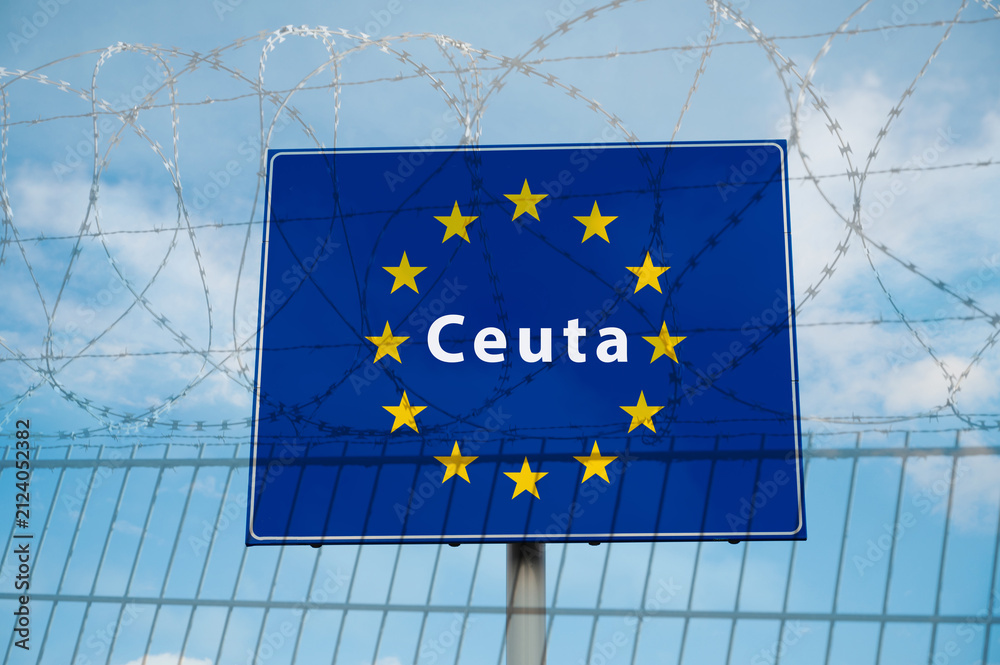 Obraz premium Ceuta border crossing, illegal immegration and migration to EU, barbed wire, refugee invasion, fence coils of razor wires, protection and security concept