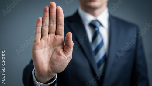 Businessman showing stop gesture with his hand