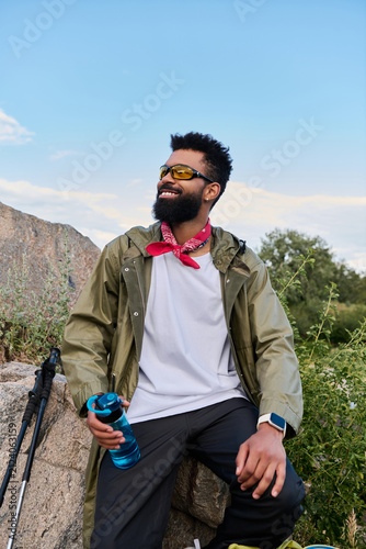 Obraz na plátne Handsome hiker enjoying the breathtaking mountain trail adventure