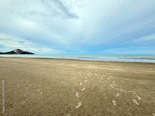 Beach Landscape with Footprints and Distant Hill