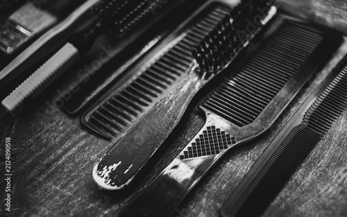 A set of combs for a haircut lie on a shelf in the salon