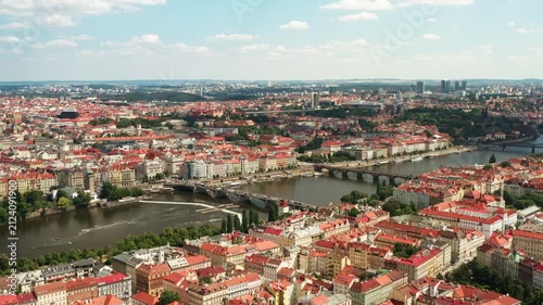 Aerial view of Prague cityscape with bridges crossing Vltava river. Historic landmark location showcases city bridges and urban skyline. Scenic panorama represents european travel destination.