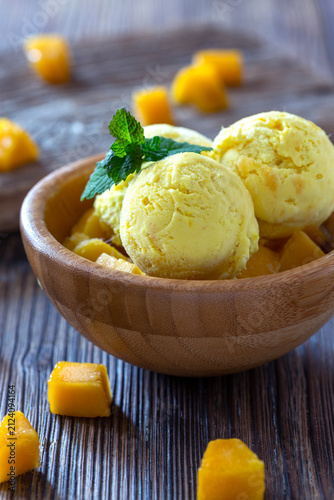 Mango ice cream in wooden bowl.