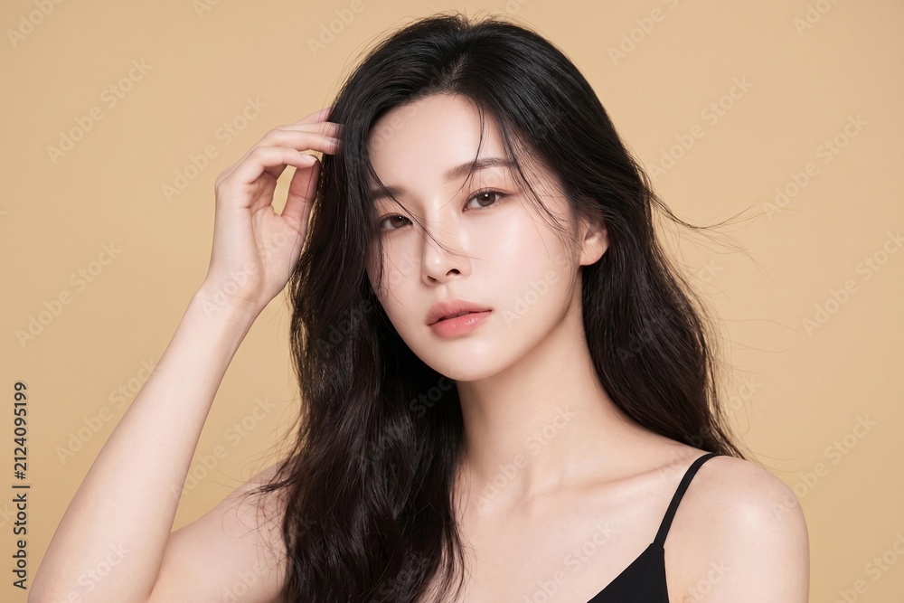 Naklejka premium Refined beauty portrait of a young woman with smooth radiant skin, luminous complexion, natural makeup, and elegant styling, ideal for luxury skincare, serums, and cosmetics advertising