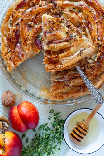 Golden spiral pie with peach and cheese layers.