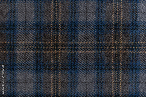 Obraz na płótnie Flat lay of a grey wool fabric with a blue and tan tartan check overlay, well suited for menswear, upholstery and autumn fashion themes