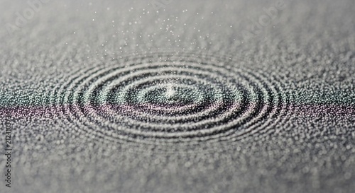 Macro view of a sparkling surface with concentric ripple patterns from vibration