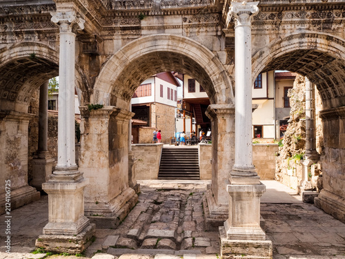 Hadrian's Gate in Antalya, Turkey, with people in background.