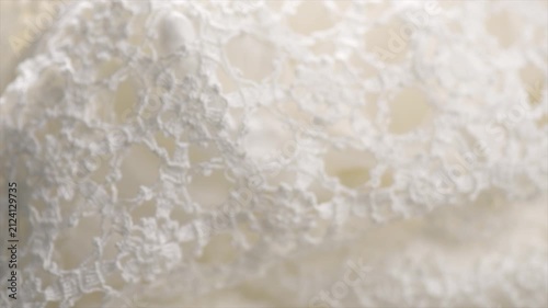 Crochet lace patterns, crocheted Grandmas Doily, Detail of hand-crocheted tablecloth background art design. Wedding tablecloth, Craft, vintage. Hobby concept. Rotating background. 