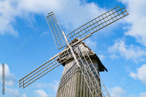 Wings of an old wooden windmill against a blue sky. Mikhailovskoye, Pushkinskie Gory. Pskov region, Russia