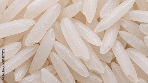 Long Grain Rice Closeup: A macro view showcases the delicate, elongated grains of white rice, highlighting their smooth texture and translucent quality, ready for culinary preparation.