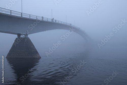 A pedestrian Humpback bridge in the morning October fog. Veliky Novgorod, Russia