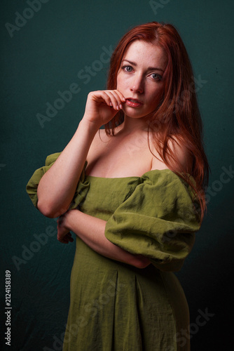 Konstfotografi emotive portrait of redhead woman in green vintage off the shoulder dress resemb