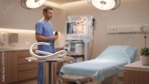 Endoscope coil sits on a clinical tray while a doctor reviews a digestive system hologram in a medical examination room.