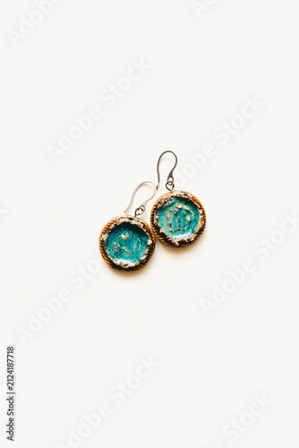 Jewelry made of ceramics. Ceramic earrings and pendant. Turquoise earrings on a white background. Handmade jewelry on a white background.