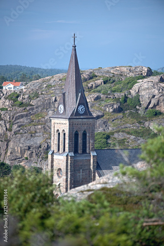Fotografie Church tower above the rooftops of a Swedish coastal town