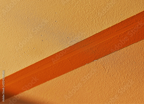 Diagonal orange line on the wall backdrop