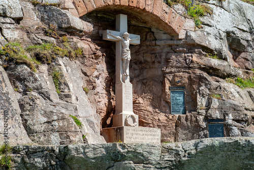 War Memorial in Bamburgh village on the North East coast, a solemn stone monument set against a coastal backdrop, reflecting remembrance and local history.
