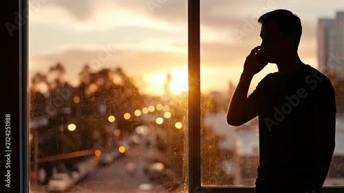 Man talking on smartphone near window 4K Video