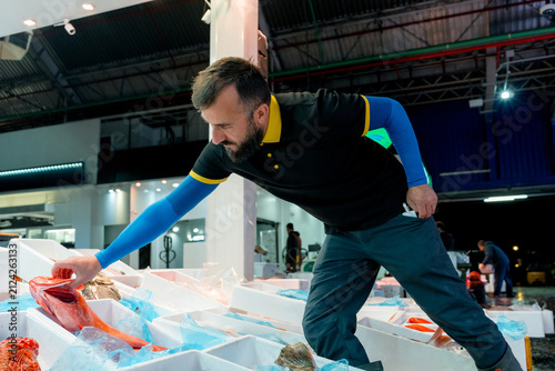 Fishmonger select fresh fish at wholesale market
