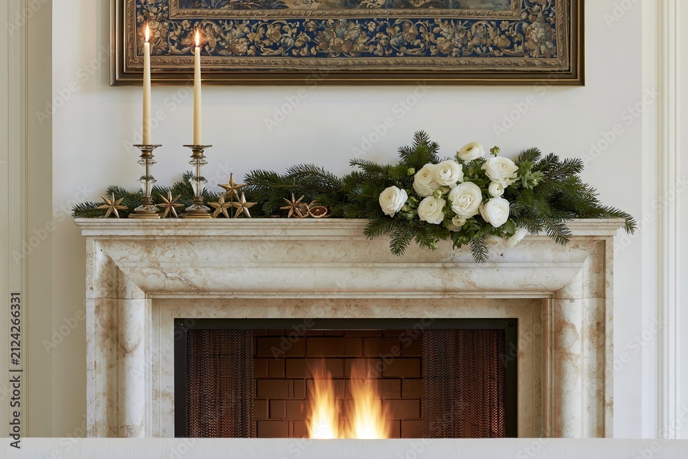 Fototapeta premium European estate Christmas fireplace mantel decorated with white roses, evergreen garland, candles, and decorative stars, featuring a warm fire in the hearth