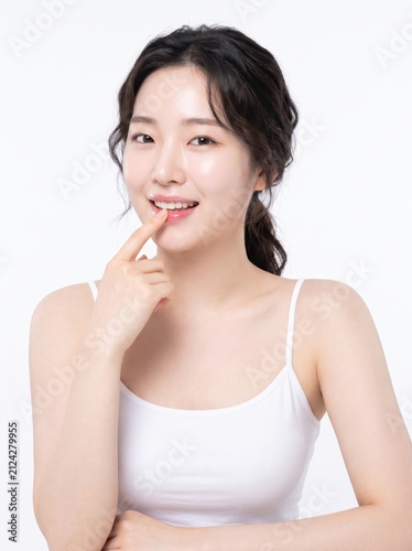 Young woman with beautiful smile and playful expression on finger
