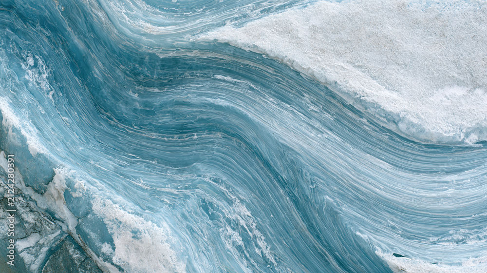 Fototapeta premium Close up of blue glacial ice texture with wavy layered patterns and snow
