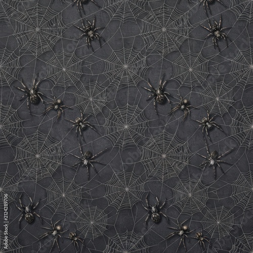 Dark spider web Halloween fabric spread across a wooden worktable for sewing, crafts and gothic textile projects.
