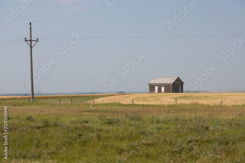 Abandoned Wooden Building in Rural Prairie Landscape