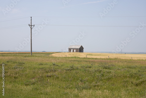 Abandoned Wooden House in Rural Prairie Landscape