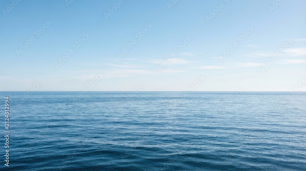 Fototapeta premium Vast blue ocean horizon with gentle waves under a clear sky