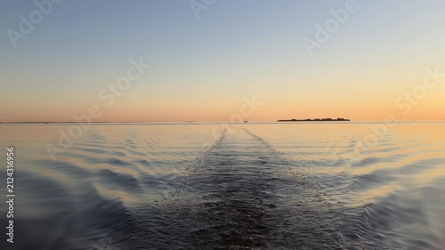 view of the sea from the stern of the boat at night