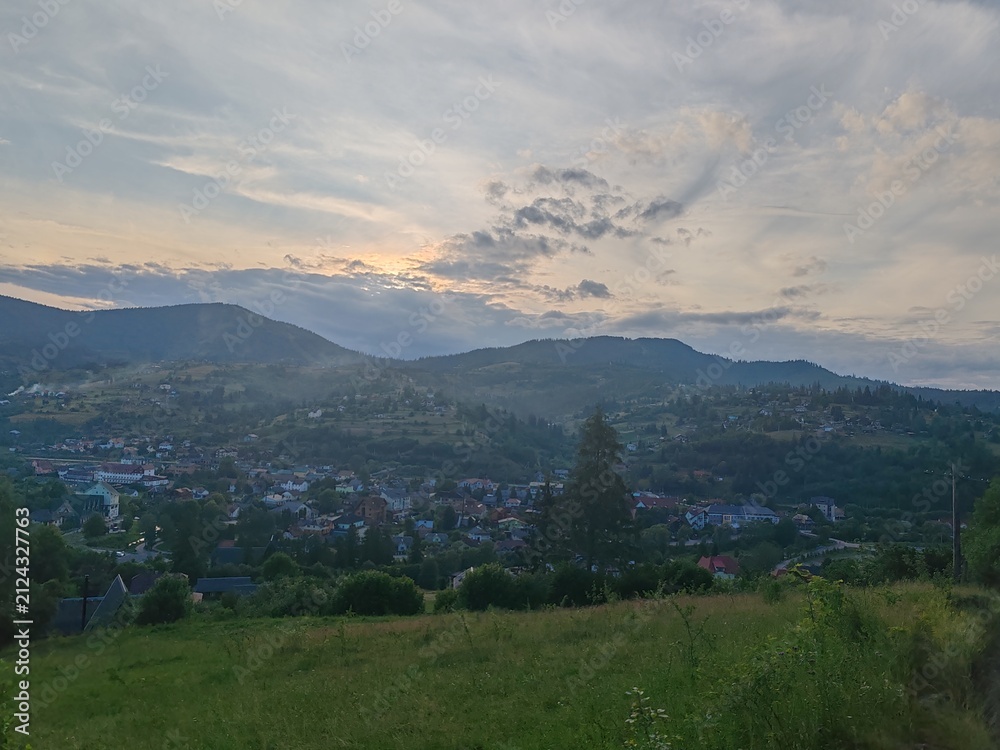 Fototapeta premium Scenic view of green Carpathian mountains hills covered with forest under cloudy sky