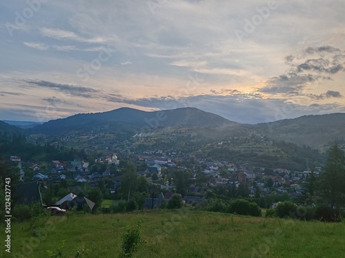 Scenic view of green Carpathian mountains hills covered with forest under cloudy sky