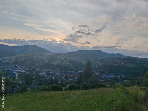 Scenic view of green Carpathian mountains hills covered with forest under cloudy sky
