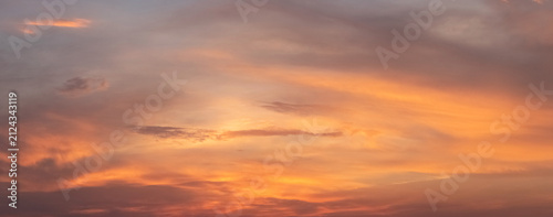 Bild auf Leinwand Bright orange sky with clouds during evening sunset