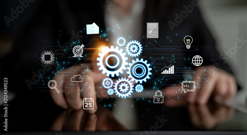 Foto Conceptual image showcasing digital innovation and technology, featuring gears, data icons, and business symbols displayed against a dark blurred background