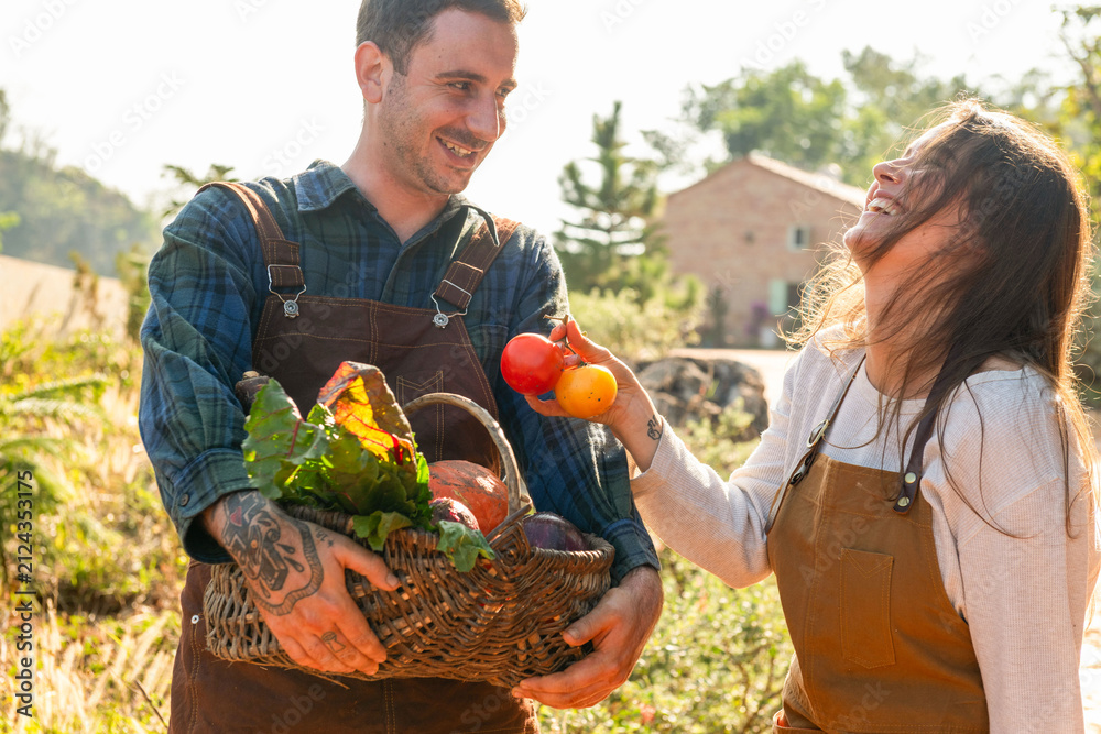 Fototapeta premium Joyful farmers harvesting fresh produce.
