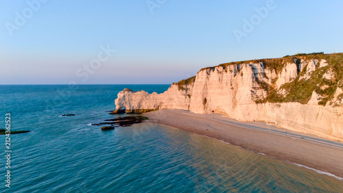 Obraz na plátně Aerial view of dramatic white cliffs and beach along the shoreline at sunset