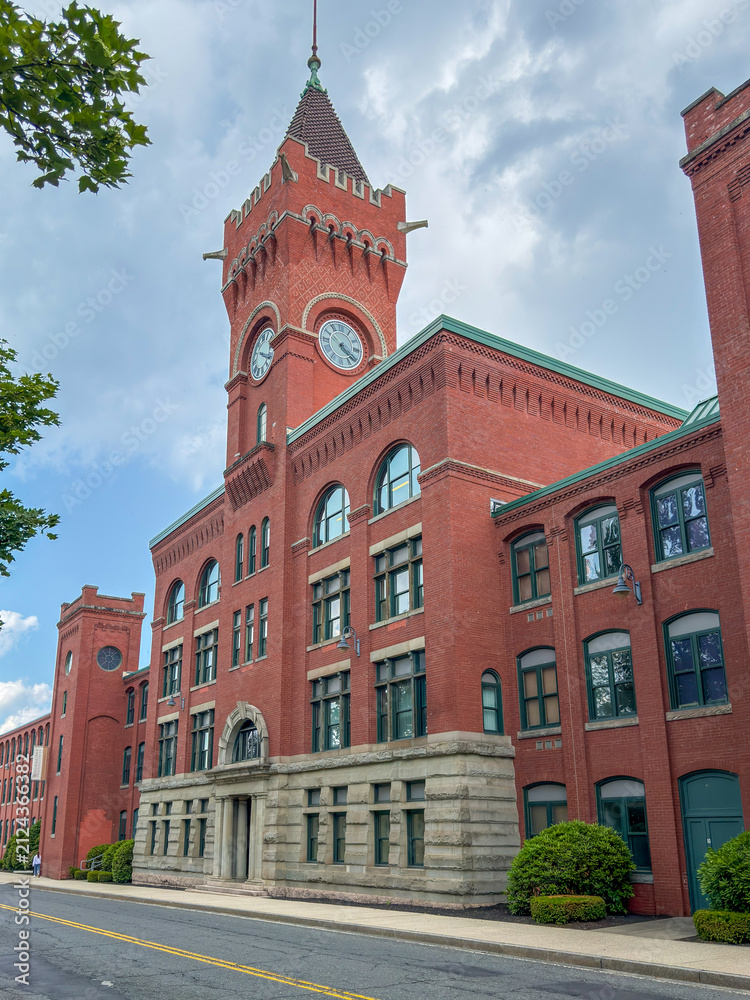 Obraz premium Historic New England Brick Factory Building with Clock Tower
